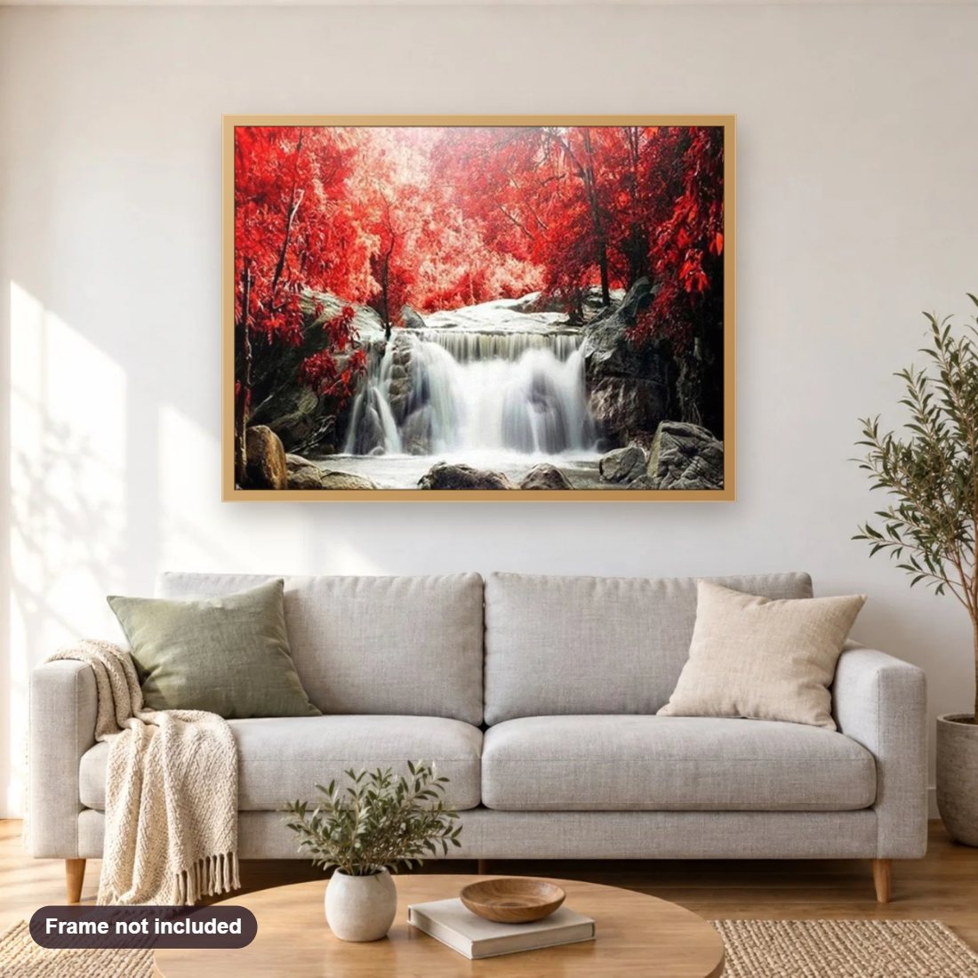Red Trees & Waterfall diamond painting shown framed on a living room wall above a sofa