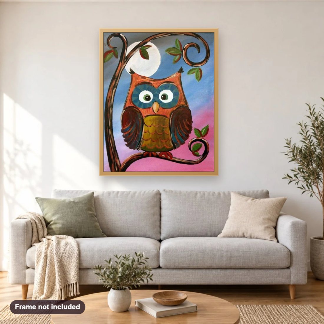 Resting Owl diamond painting shown framed on a living room wall above a sofa