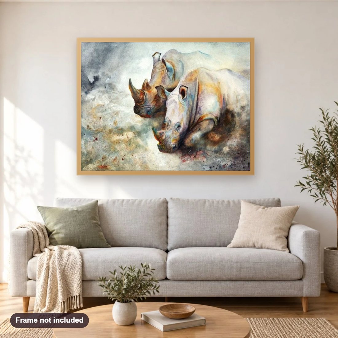 Rhinos Pair diamond painting shown framed on a living room wall above a sofa