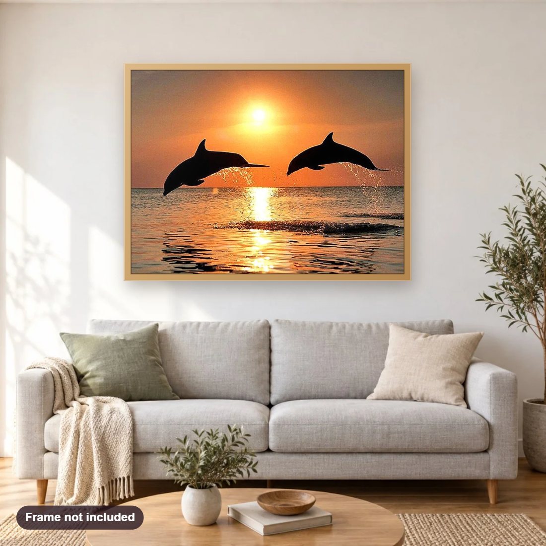 Sea Dolphins & Sunset View diamond painting shown framed on a living room wall above a sofa