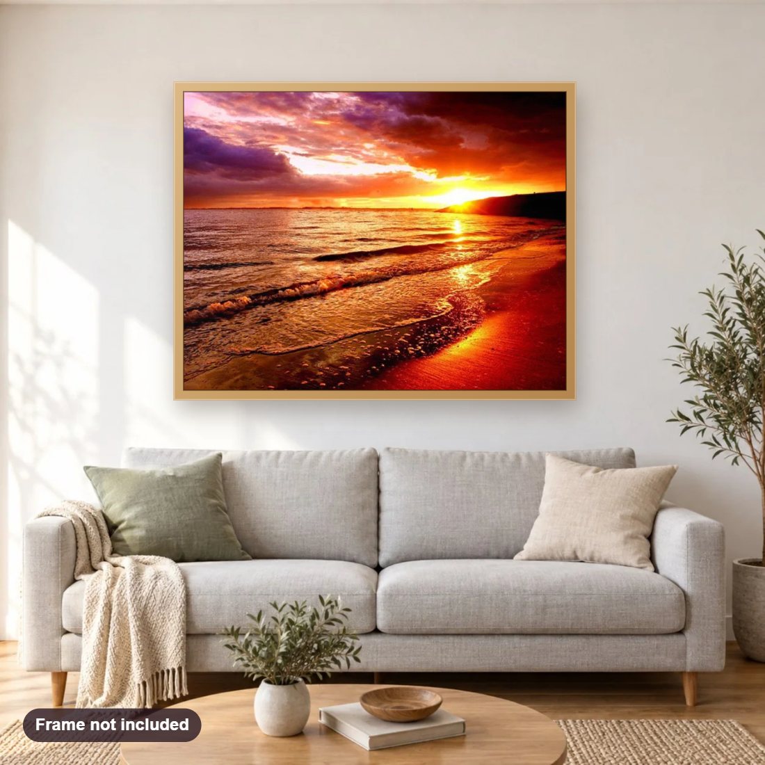 Sea Waves & Sunset diamond painting shown framed on a living room wall above a sofa