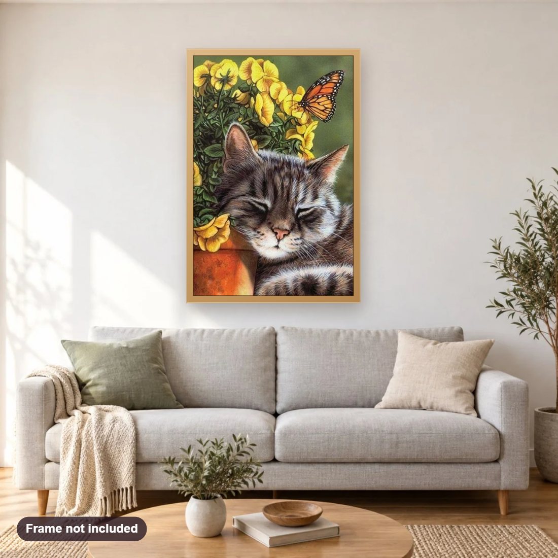 Sleeping Cat diamond painting shown framed on a living room wall above a sofa