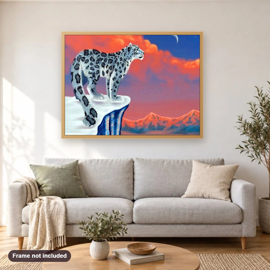 Snow Leopard & Red Sky diamond painting shown framed on a living room wall above a sofa
