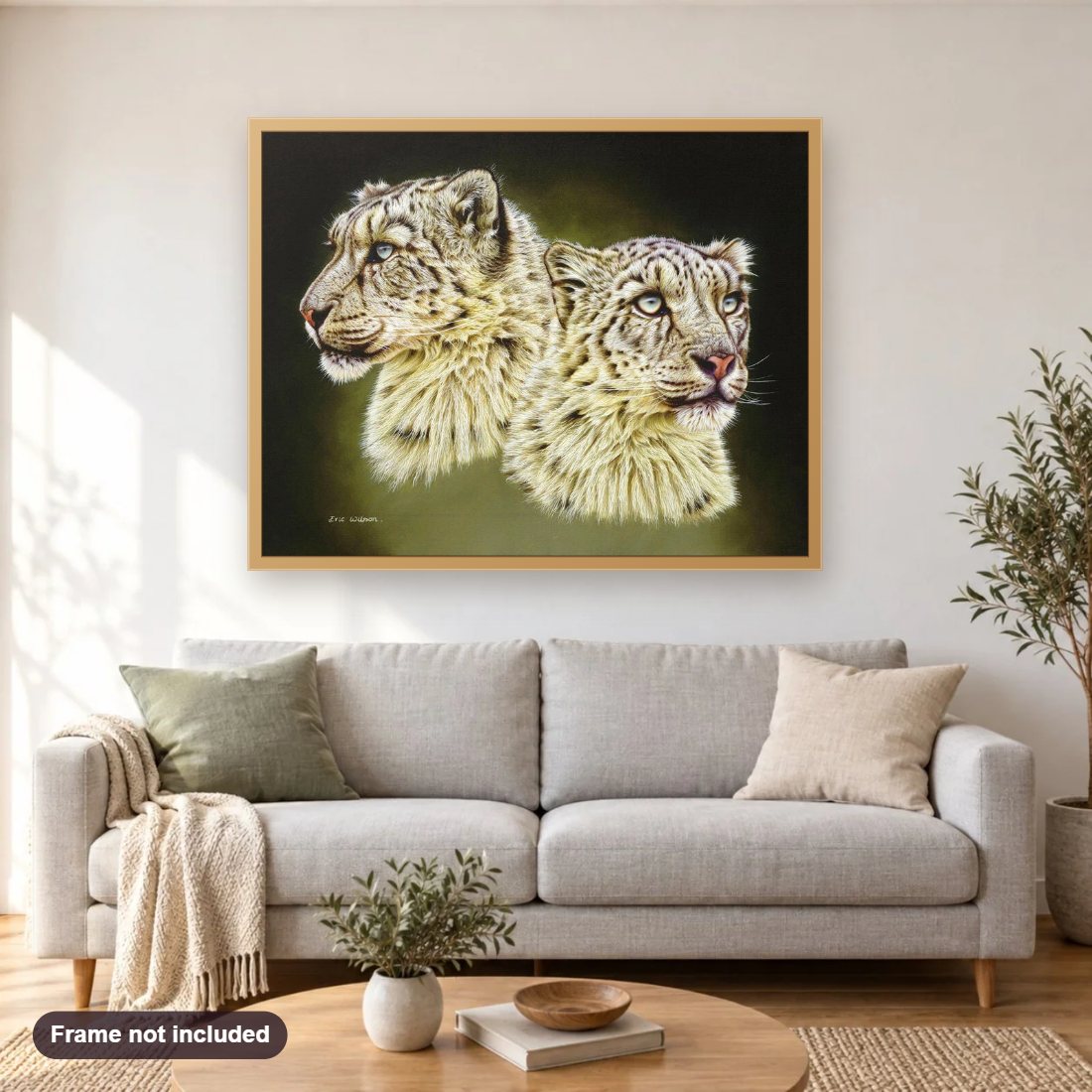 Snow Leopards diamond painting shown framed on a living room wall above a sofa