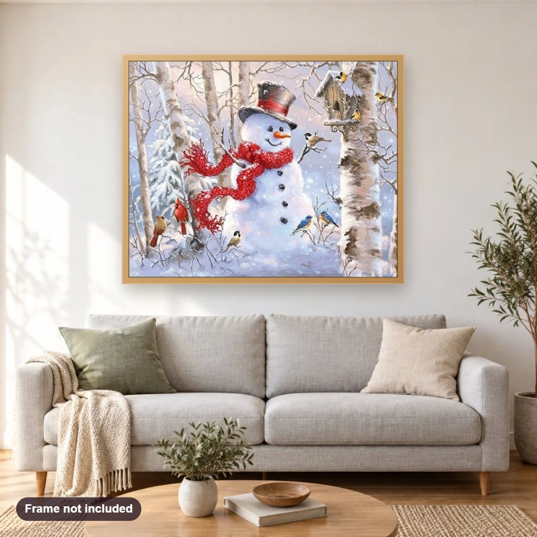 Snow Man & Bird House diamond painting shown framed on a living room wall above a sofa