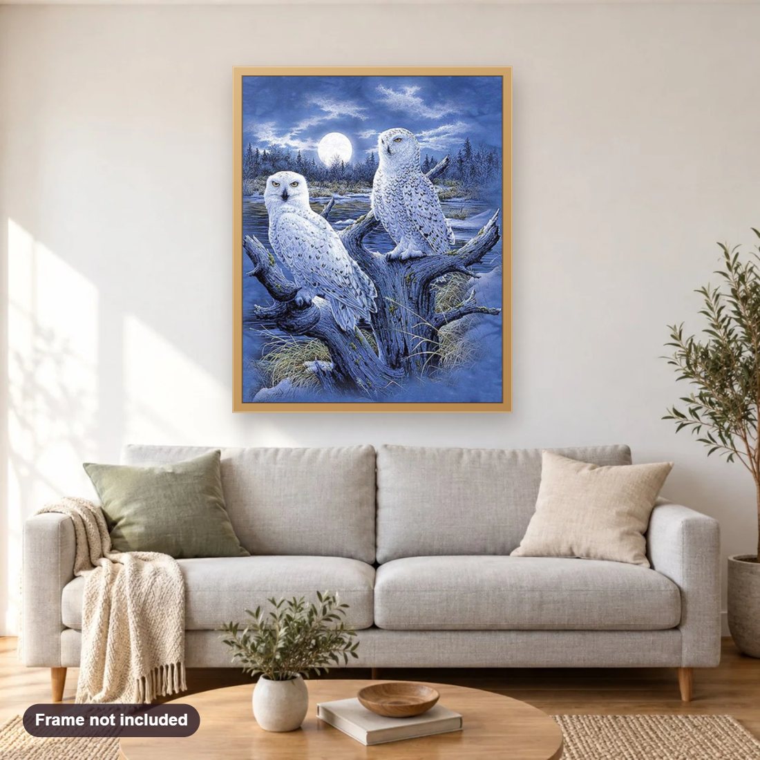 Snow Owls Pair diamond painting shown framed on a living room wall above a sofa