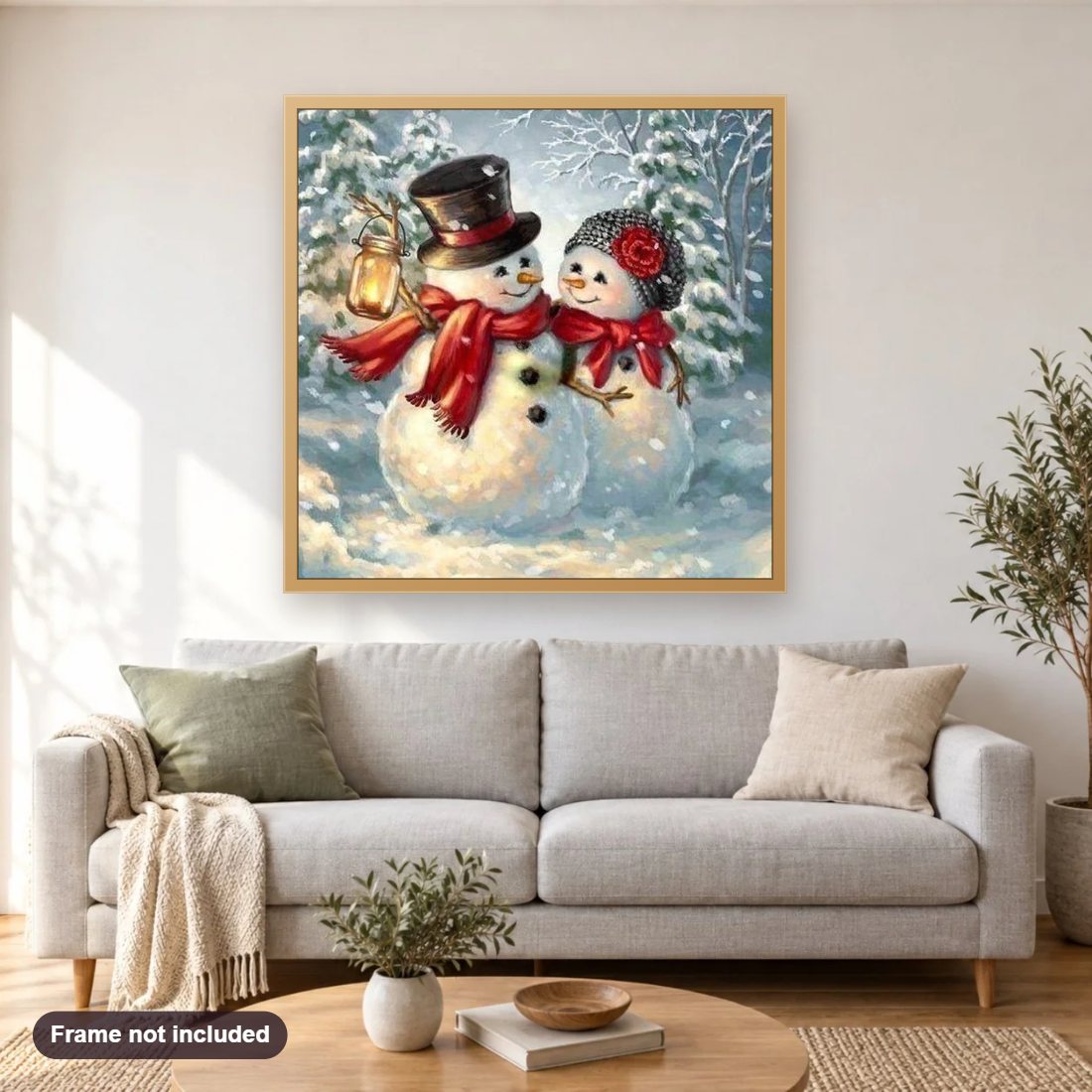Snowman diamond painting shown framed on a living room wall above a sofa