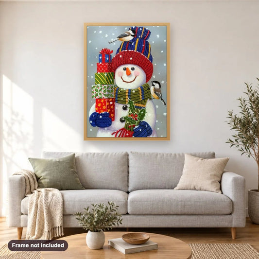 Snowman with Christmas Gifts diamond painting shown framed on a living room wall above a sofa