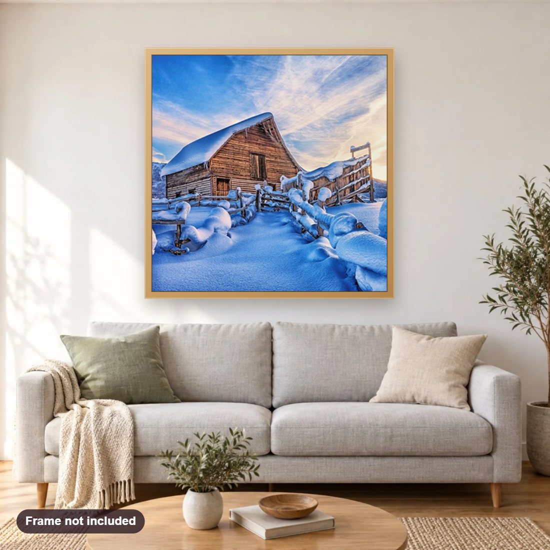 Snowy Cabin diamond painting shown framed on a living room wall above a sofa
