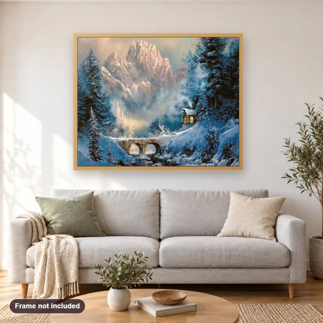 Snowy Landscape diamond painting shown framed on a living room wall above a sofa
