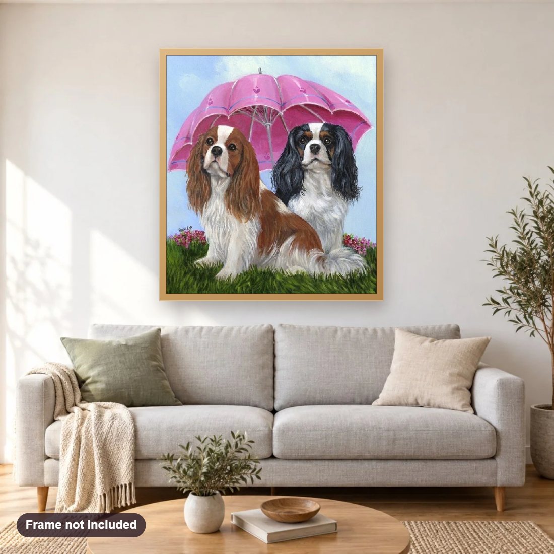 Spaniels Under Umbrella diamond painting shown framed on a living room wall above a sofa