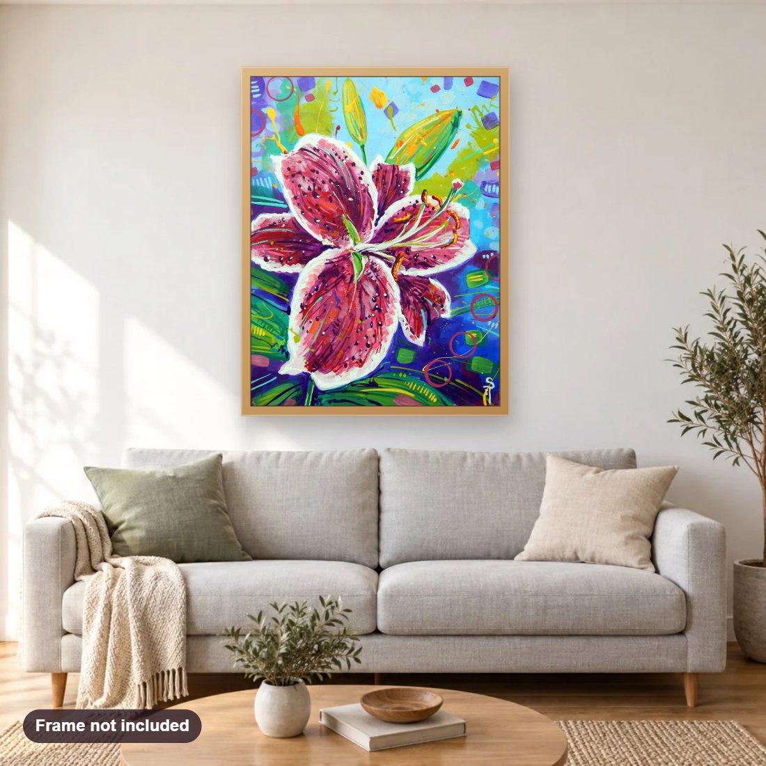 Stargazer Lily diamond painting shown framed on a living room wall above a sofa
