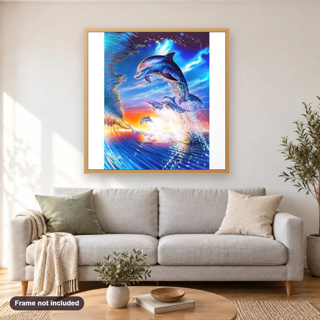 Sunrise Dolphins diamond painting shown framed on a living room wall above a sofa
