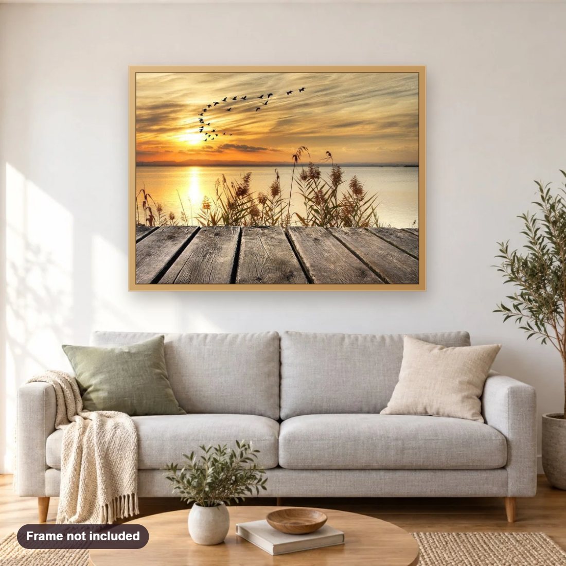 Sunset Lake & Birds diamond painting shown framed on a living room wall above a sofa