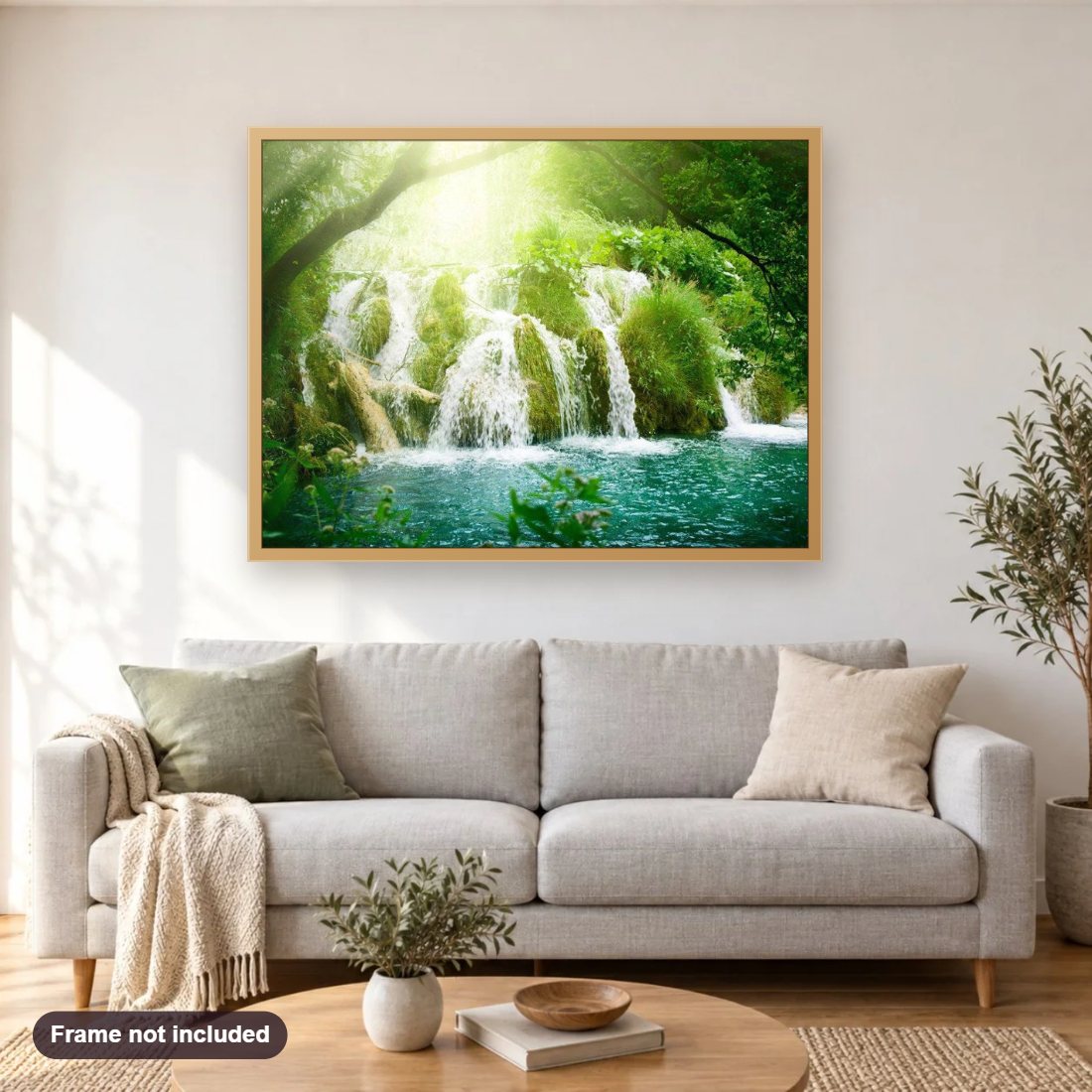 Sunshine & Forest Waterfall diamond painting shown framed on a living room wall above a sofa