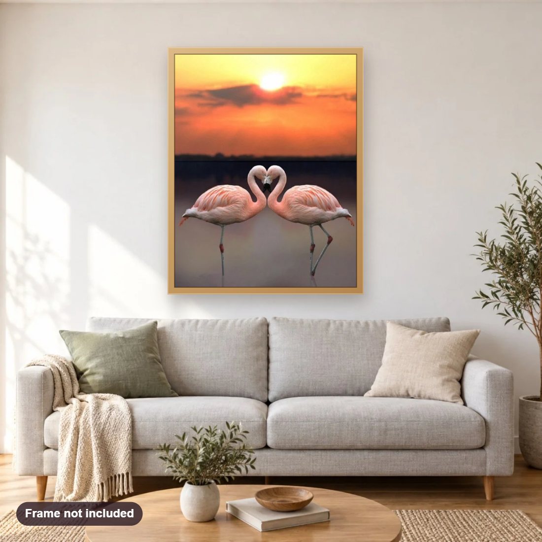 Flamingos & Sunset Landscape diamond painting shown framed on a living room wall above a sofa