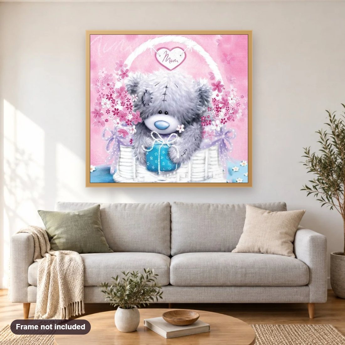Teddy in the Basket diamond painting shown framed on a living room wall above a sofa