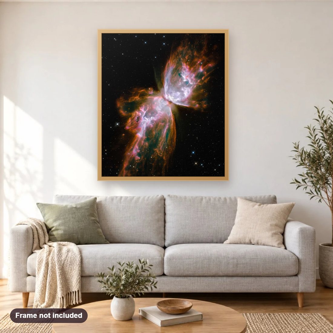 The Butterfly Nebula diamond painting shown framed on a living room wall above a sofa