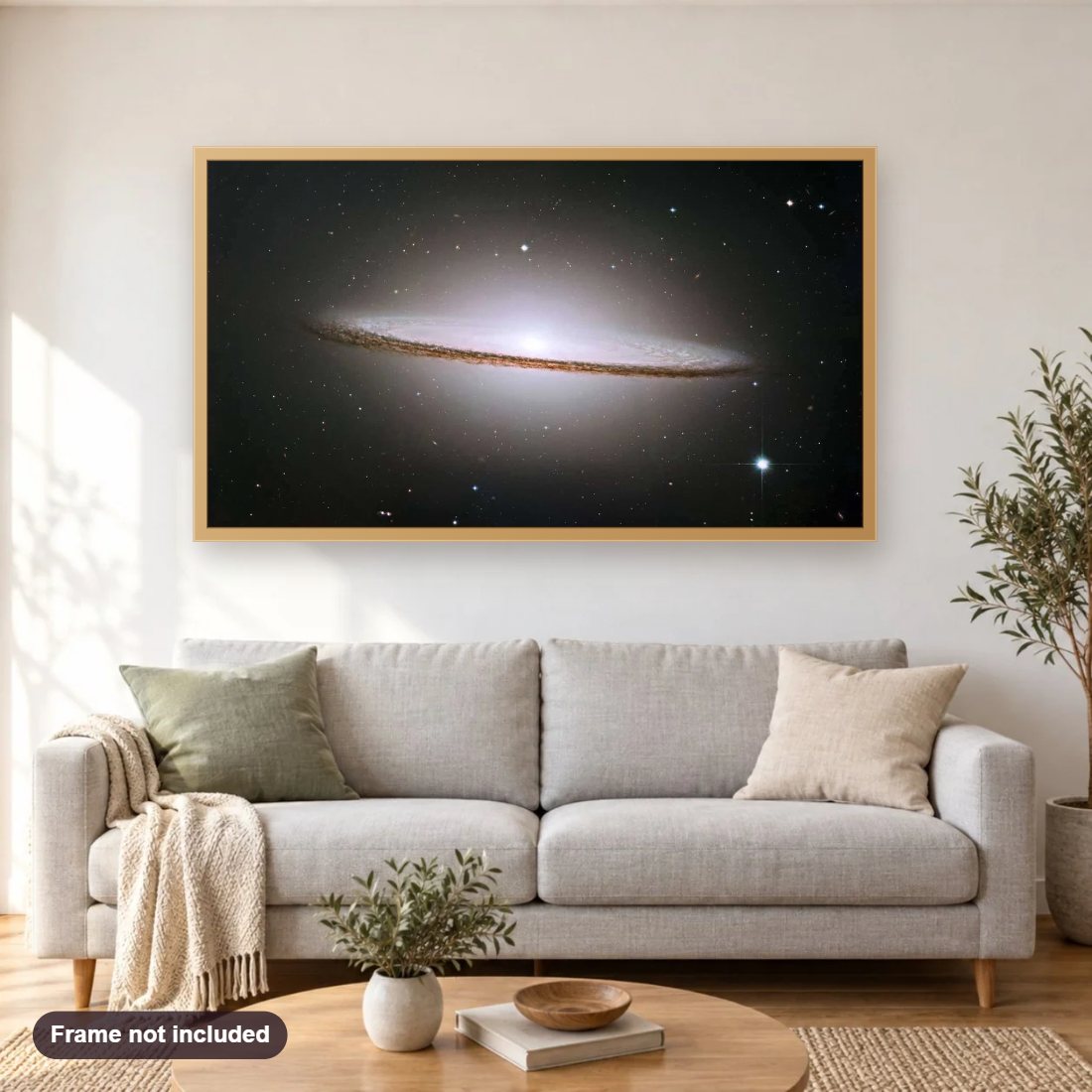 The Sombrero Galaxy diamond painting shown framed on a living room wall above a sofa
