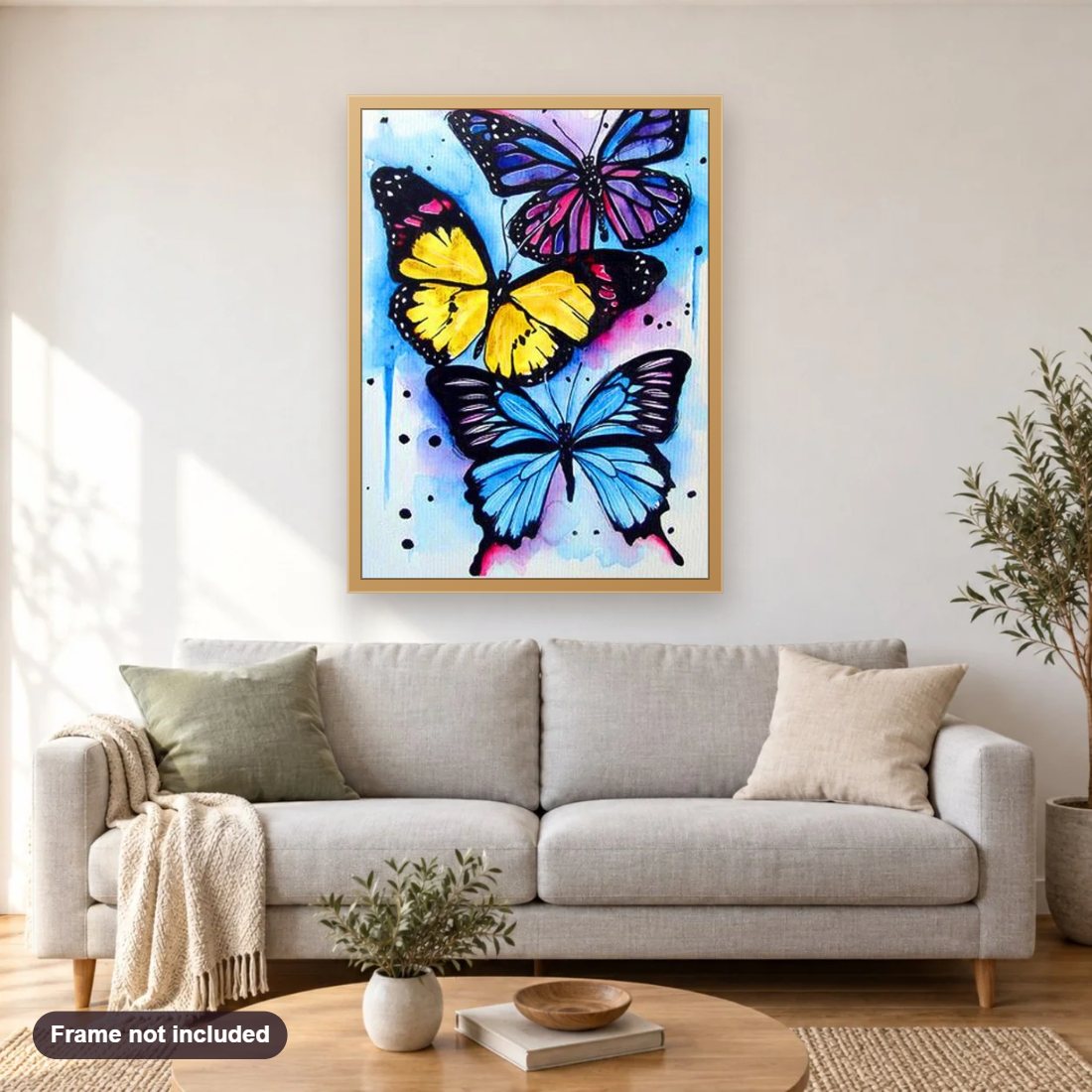 Three Colorful Butterflies diamond painting shown framed on a living room wall above a sofa