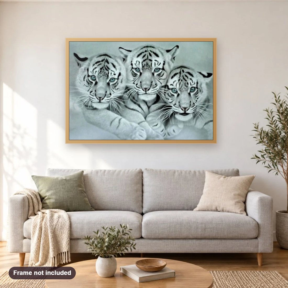 Three White Tigers diamond painting shown framed on a living room wall above a sofa