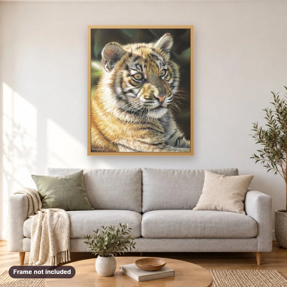 Tiger Cub diamond painting shown framed on a living room wall above a sofa