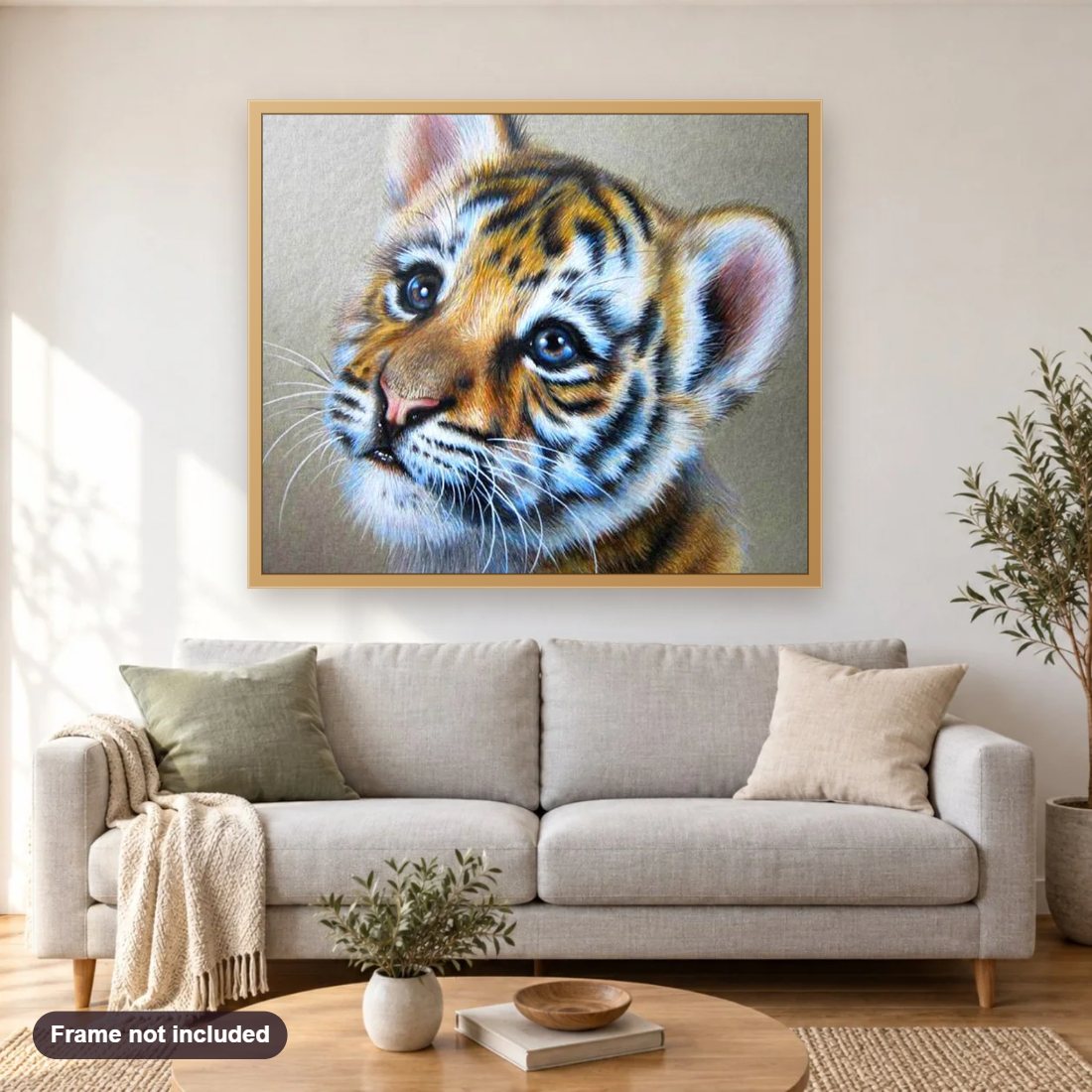 Tiger Cub diamond painting shown framed on a living room wall above a sofa