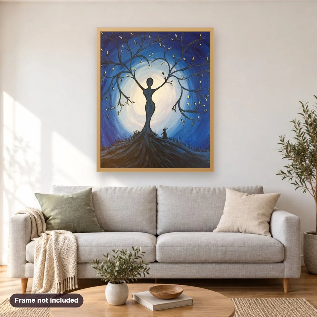 Tree Lady diamond painting shown framed on a living room wall above a sofa
