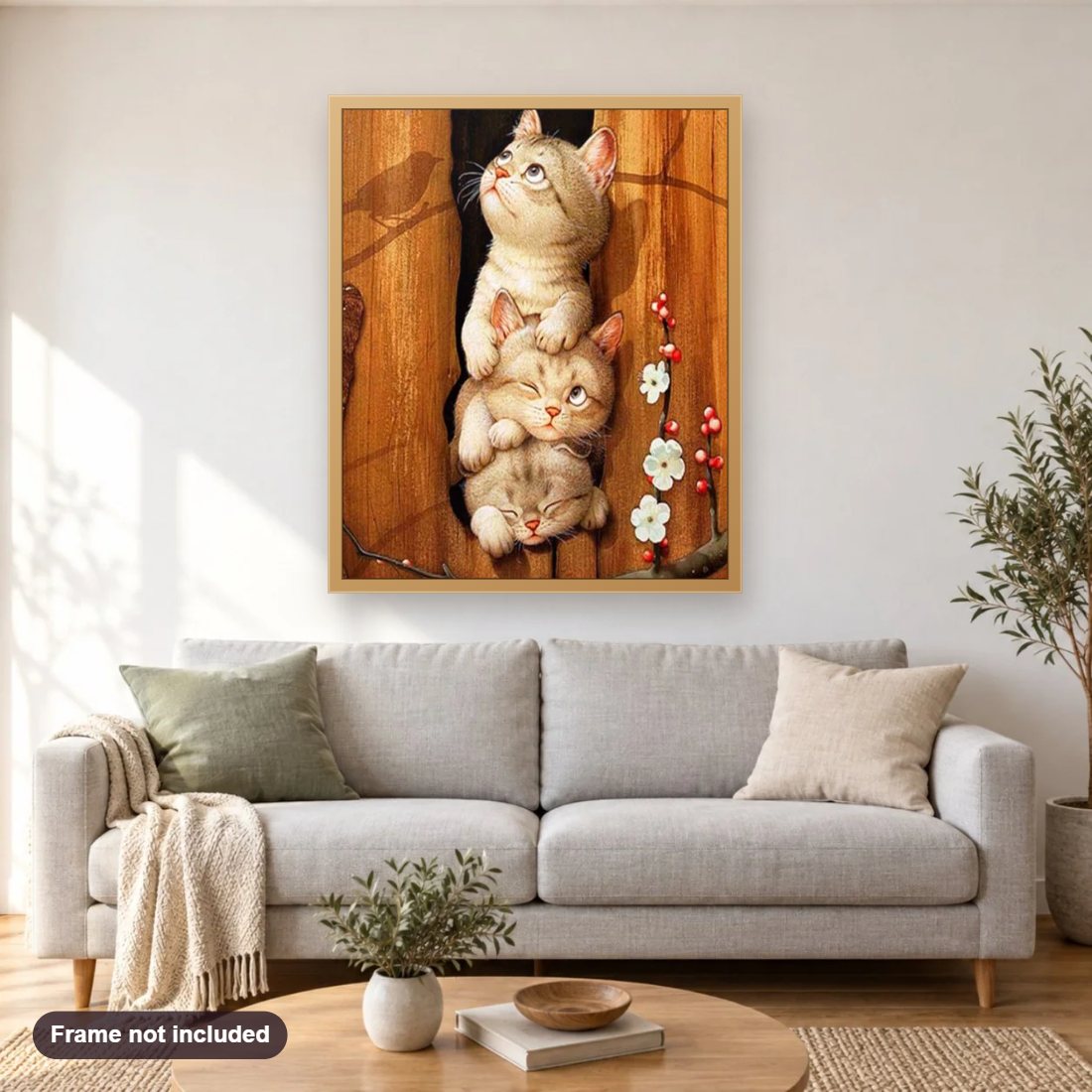 Triplets Cats diamond painting shown framed on a living room wall above a sofa