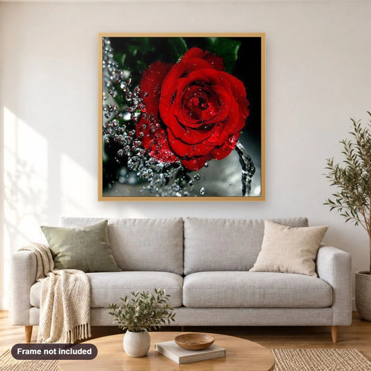 Water Splashing on Red Rose diamond painting shown framed on a living room wall above a sofa