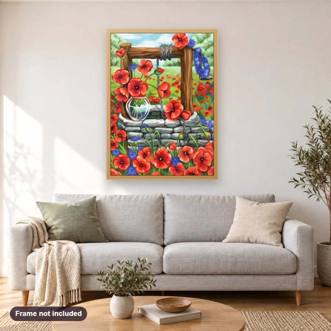 Water Well & Flowers diamond painting shown framed on a living room wall above a sofa