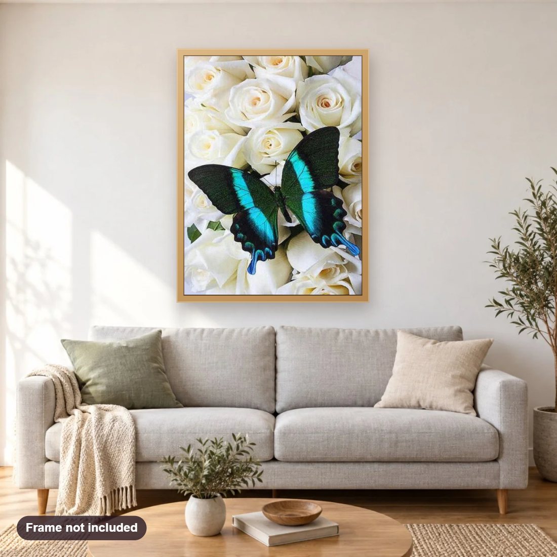 White Roses & Butterfly diamond painting shown framed on a living room wall above a sofa