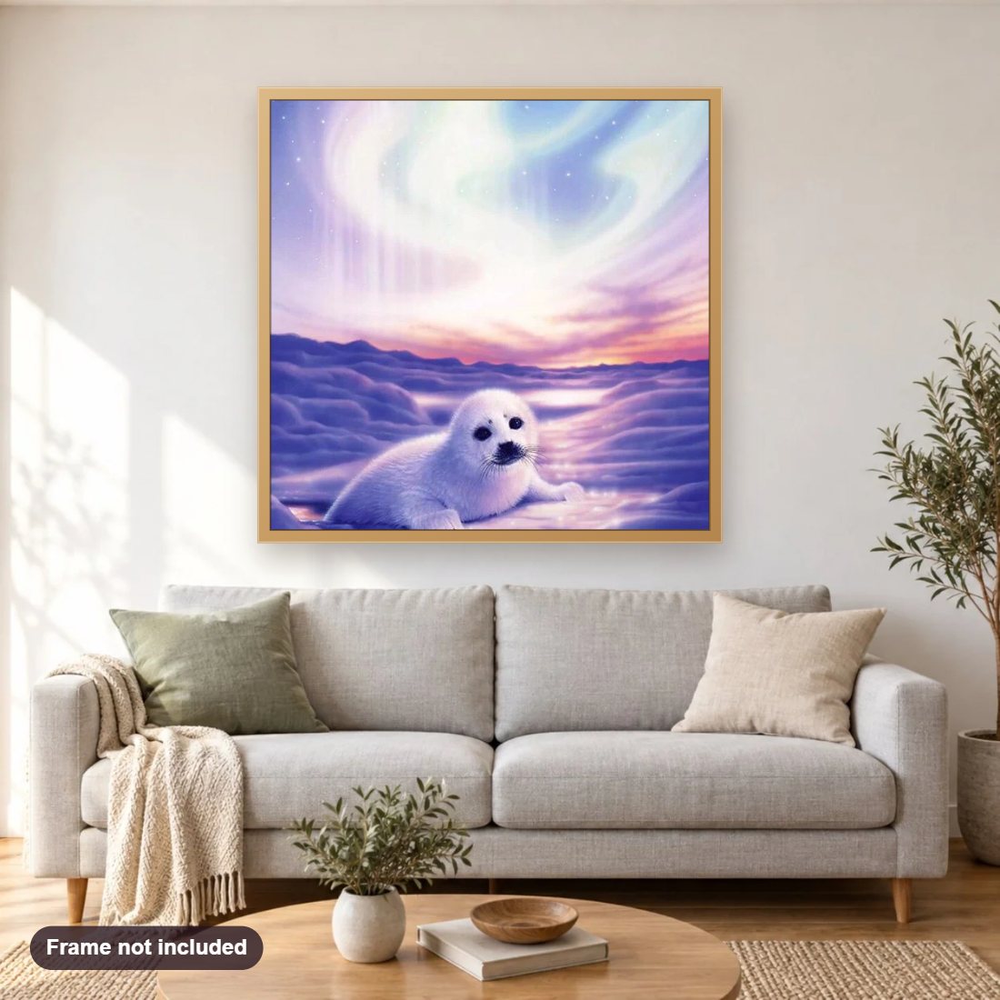 White Seal diamond painting shown framed on a living room wall above a sofa