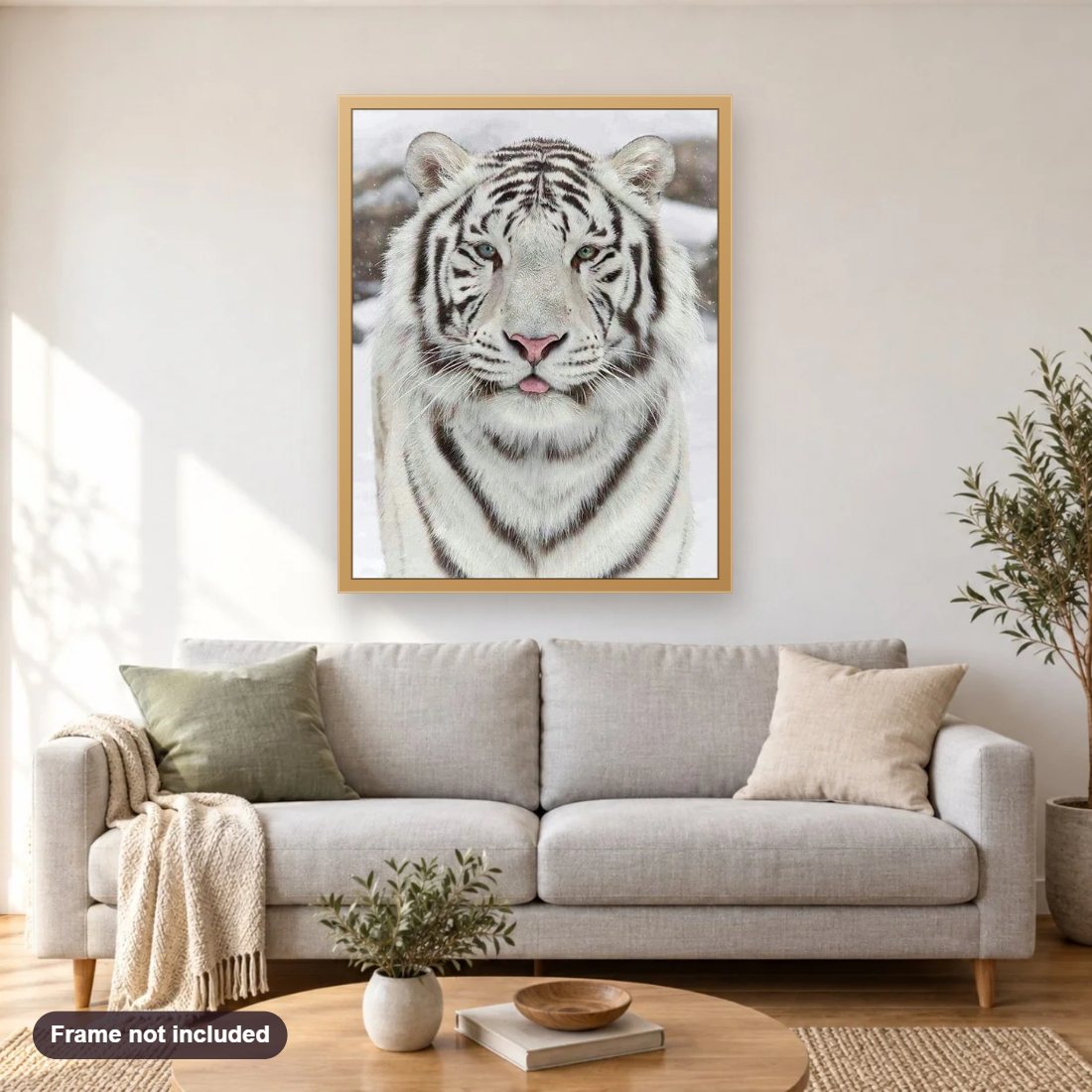 White Tiger in Snow diamond painting shown framed on a living room wall above a sofa
