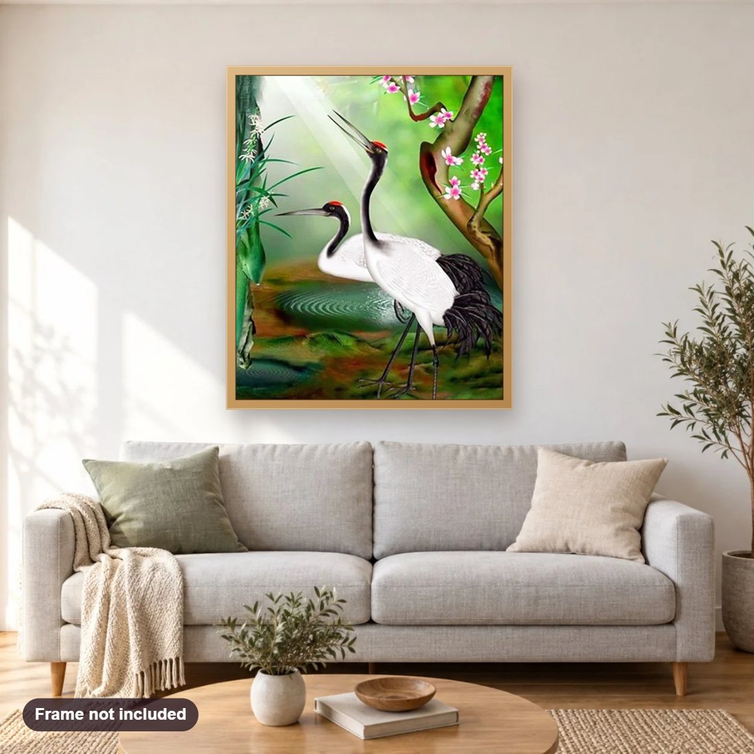 Whooping Crane Pair diamond painting shown framed on a living room wall above a sofa