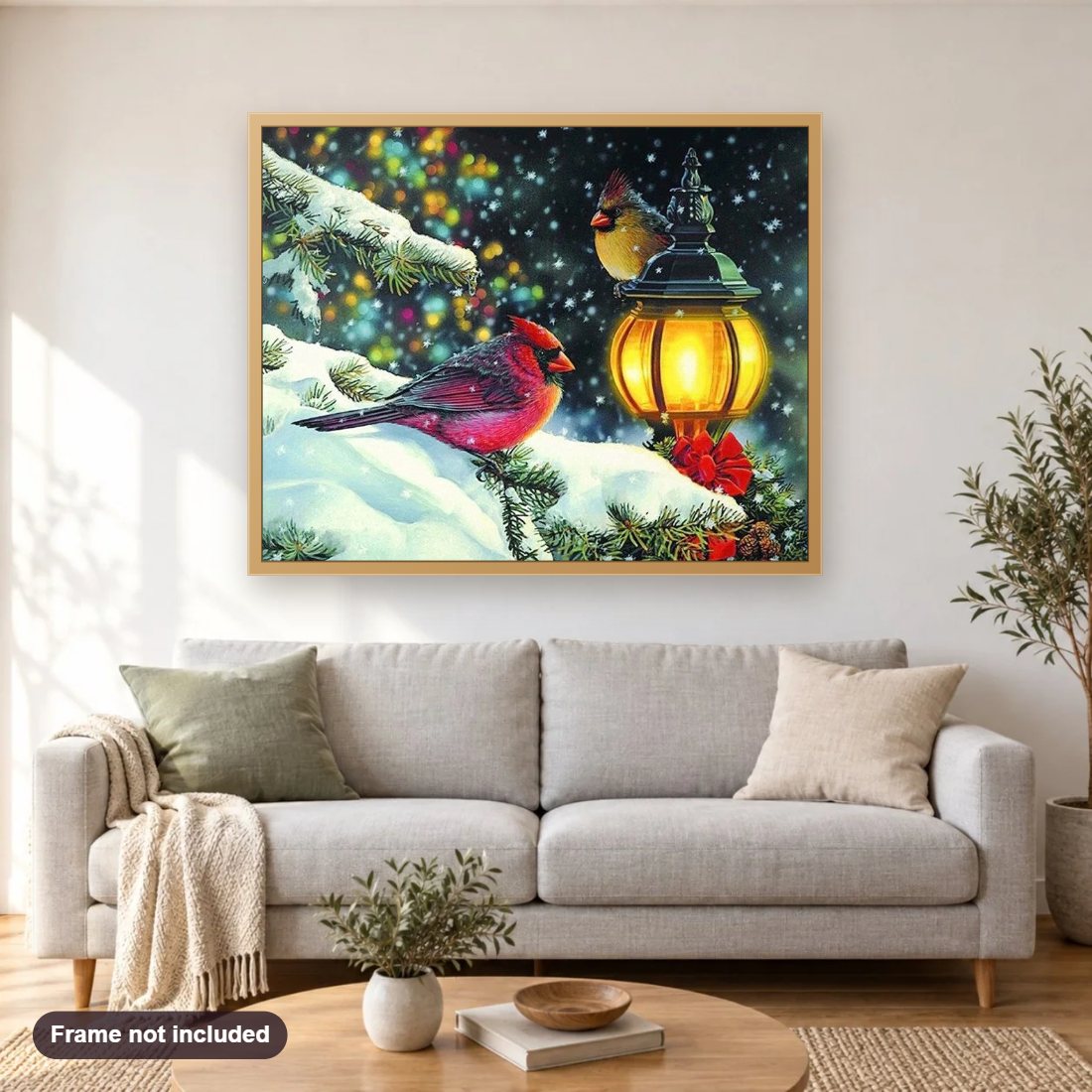 Winter Birds diamond painting shown framed on a living room wall above a sofa