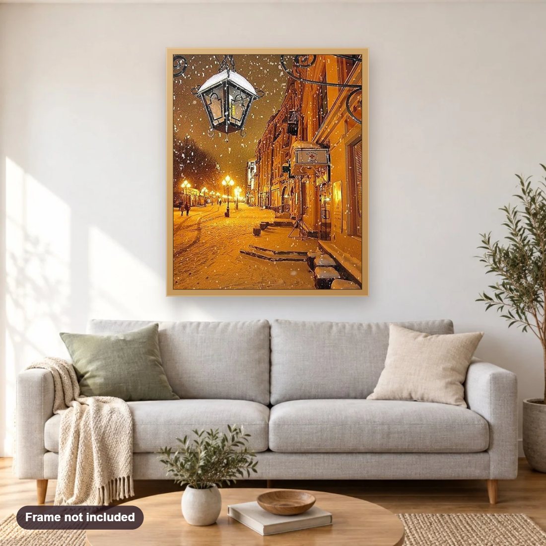 Winter Night Street View diamond painting shown framed on a living room wall above a sofa