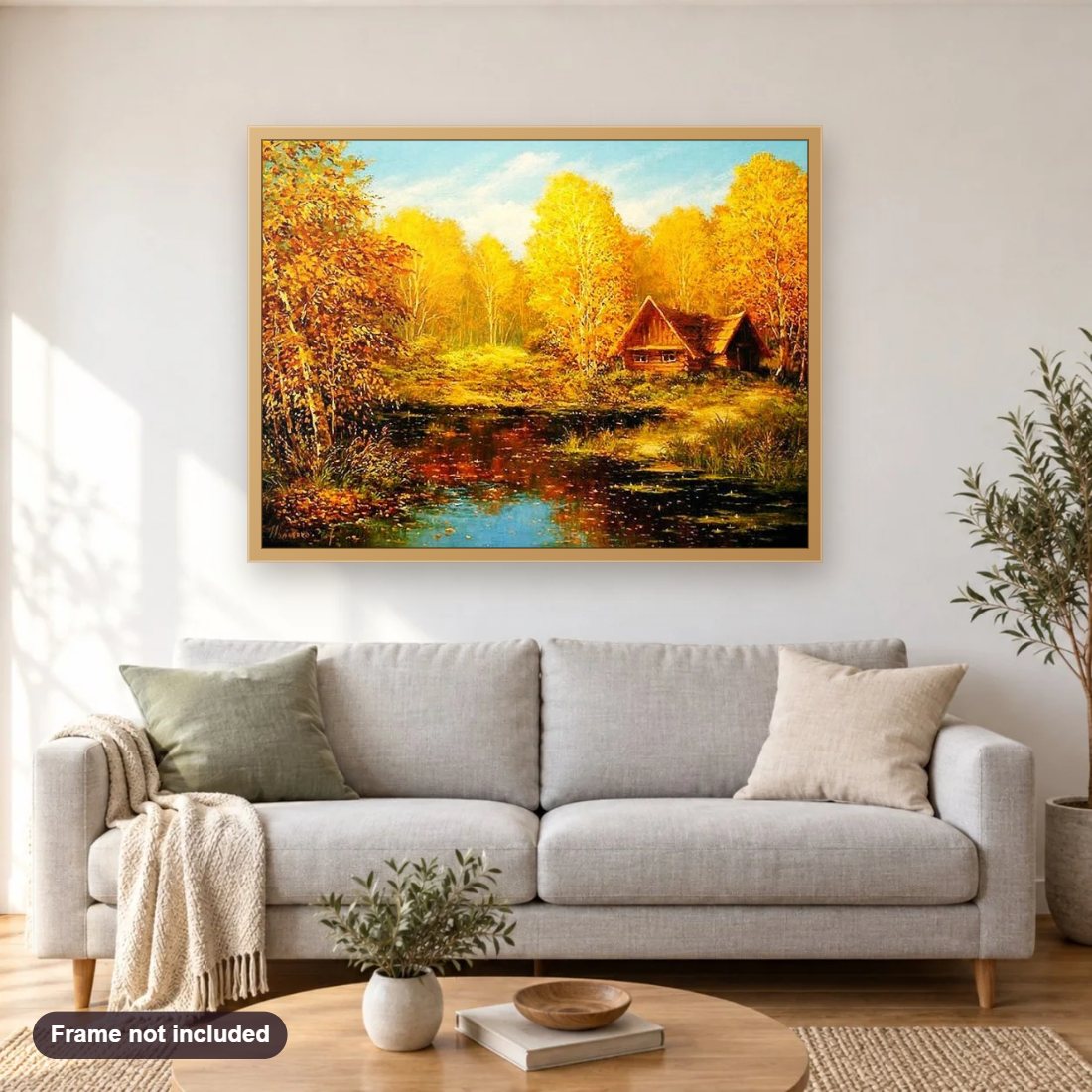 Yellow Autumn Trees & Hut diamond painting shown framed on a living room wall above a sofa