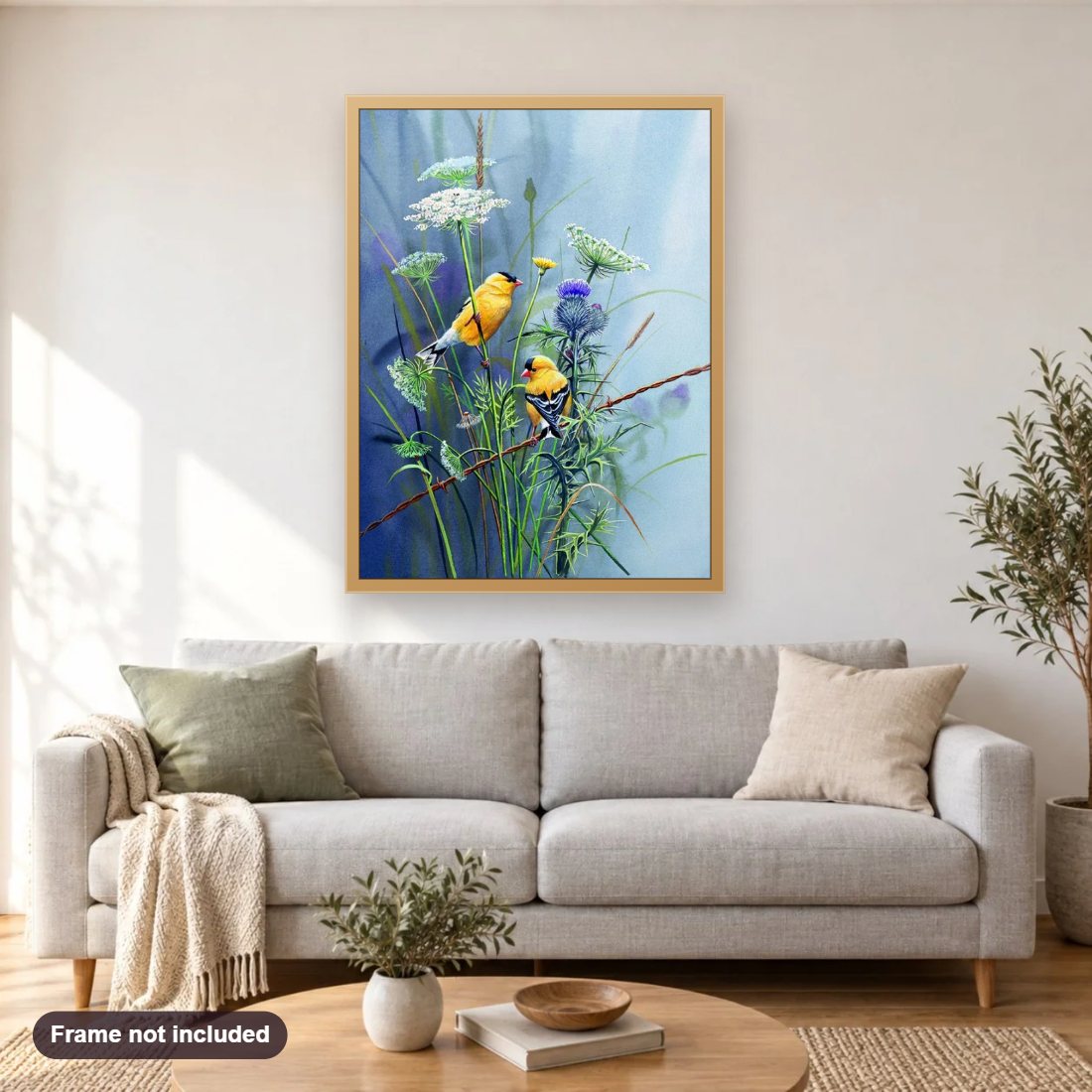 Yellow Birdies diamond painting shown framed on a living room wall above a sofa