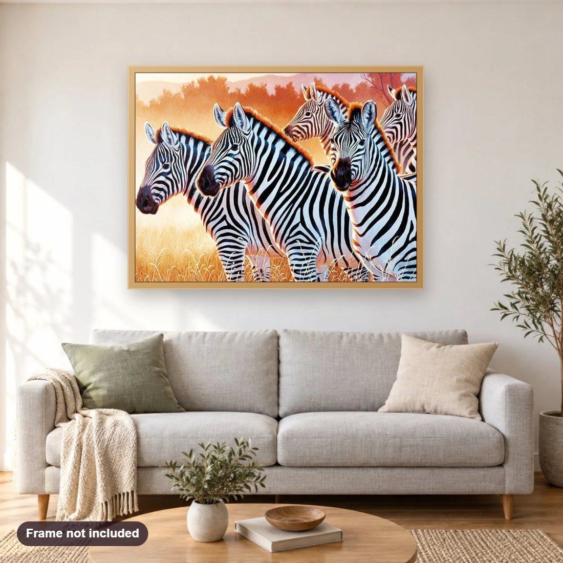 Zebras diamond painting shown framed on a living room wall above a sofa